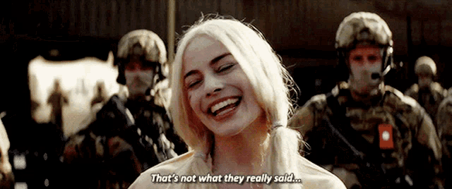 a woman is laughing in front of soldiers and says that 's not what they really said