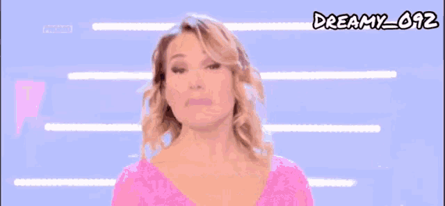 a woman in a pink top with the words un'altra grande avventura on the bottom
