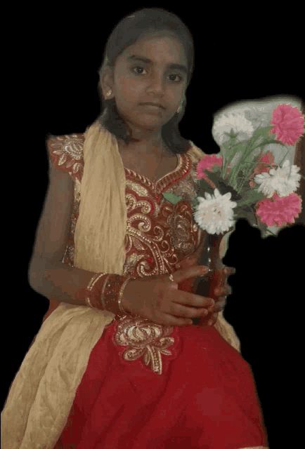 a young girl in a red dress holds a vase of flowers