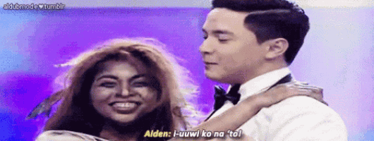 a man in a tuxedo is hugging a woman who is smiling and says " alden "