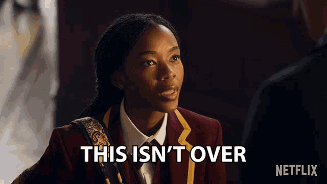 a woman in a red suit says this isn 't over in white letters