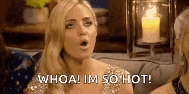 a woman is sitting on a couch with her mouth open and says `` whoa ! im so hot ! ''