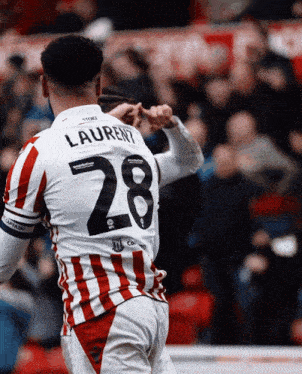 a soccer player with laurent on his jersey