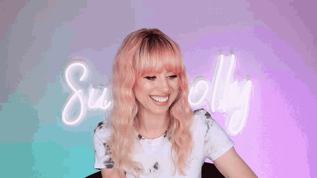 a woman with pink hair says me encanta in front of a neon sign