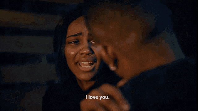 a man and a woman are hugging and the woman is crying and says i love you