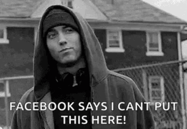 eminem is wearing a hoodie and a beanie and says `` facebook says i cant put this here '' .