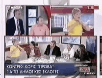 a group of people sitting around a table on a tv show