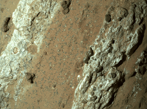 a close up of a rocky surface with a few small rocks