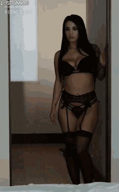 a woman in lingerie is standing in a doorway in a bedroom .
