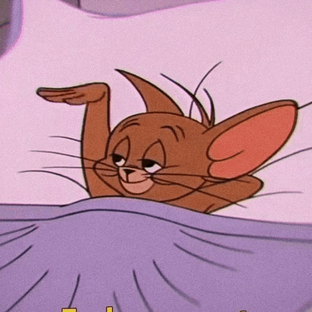 a close up of a cartoon cat laying on a bed