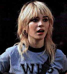 a woman wearing a t-shirt that says why on it