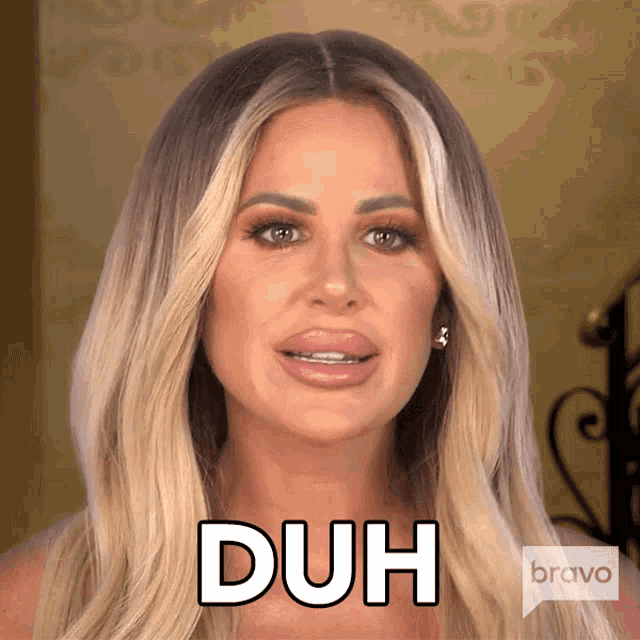 a woman with blonde hair is making a funny face and says duh
