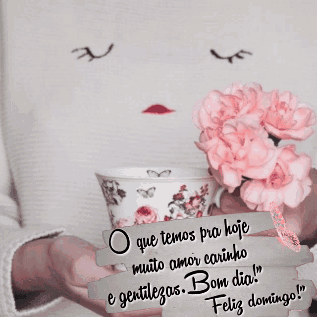 a woman is holding a cup of coffee with pink flowers in her hands