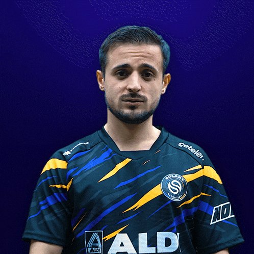 a man wearing a shirt with aldi on it