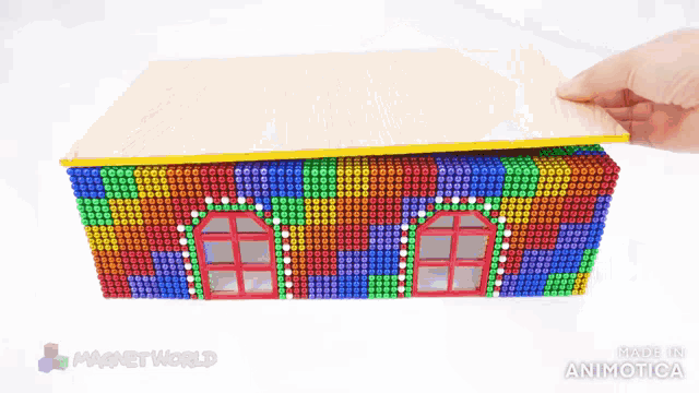 a person is holding a bunch of magnet beads in their hand