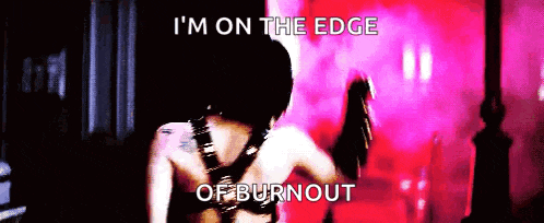 a woman is standing in front of a pink background with the words i 'm on the edge of burnout written on it