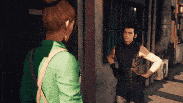 a woman in a green shirt talks to a man in a leather vest