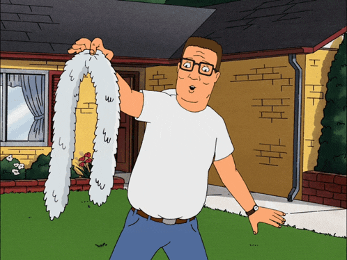 a man in a white shirt is holding a furry item