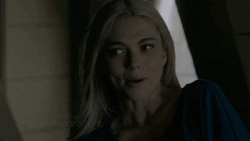 a close up of a woman 's face in a dark room .
