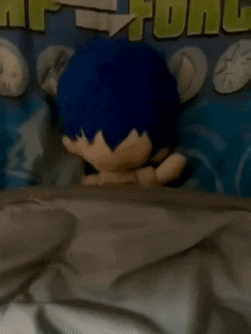 a stuffed toy with blue hair is laying on a bed in front of a sign that says " hp = fon "