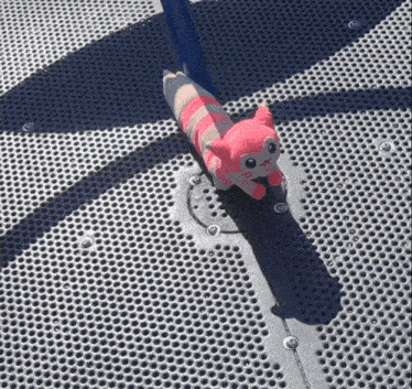 a stuffed animal laying on a metal surface