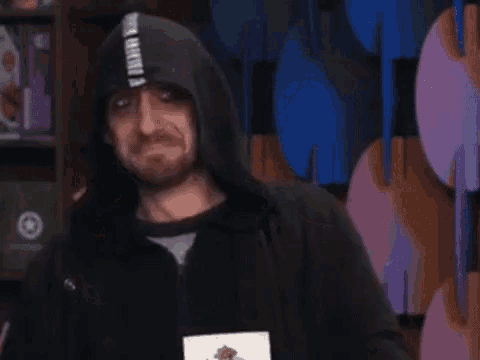 a man wearing a black hoodie with a white stripe on it