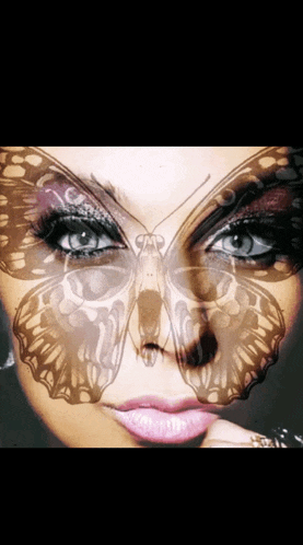 a close up of a woman 's face with a butterfly painted on it