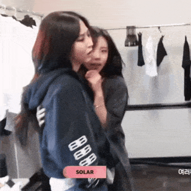a girl wearing a hoodie with the word solar on it