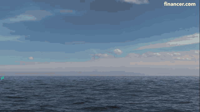 a yellow coin with the letter b on it is floating in the ocean