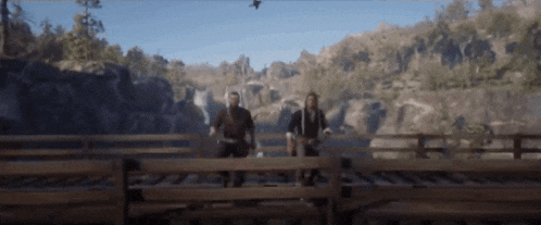 a blurry picture of two men standing on a bridge .