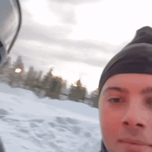 a close up of a person 's face with a helmet in the background