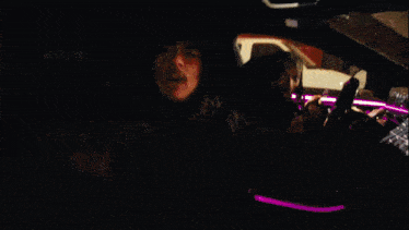 a man in a hooded jacket sits on the stairs