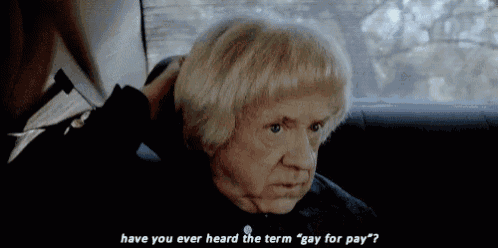 an elderly man with blonde hair is sitting in a car and talking to someone .