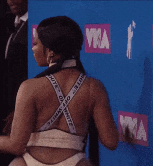 a woman stands in front of a sign that says ' vma ' on it