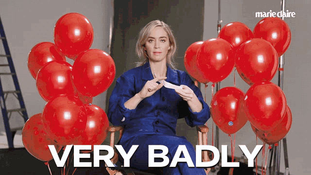 a woman sitting in a chair with red balloons and the words very badly behind her