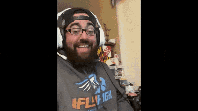 a man with a beard wearing headphones and a shirt that says flytech