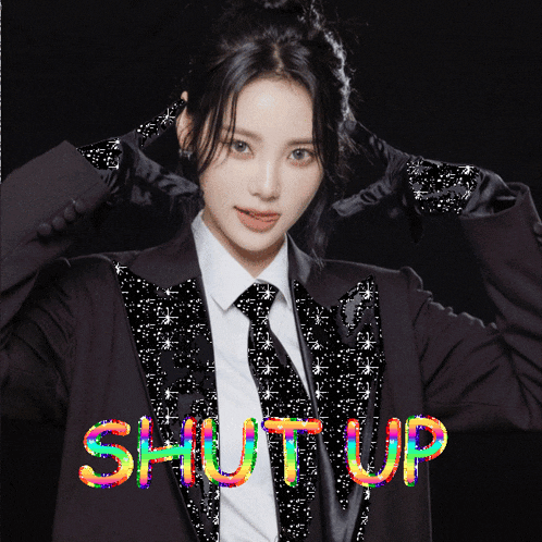 a woman in a suit and tie with the word shut up written on the bottom