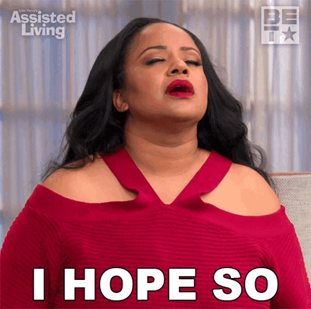 a woman says i hope so while wearing a red dress