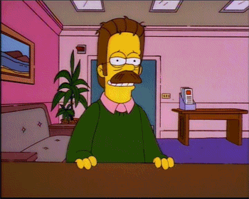 a cartoon character with a green sweater and a mustache is sitting at a desk