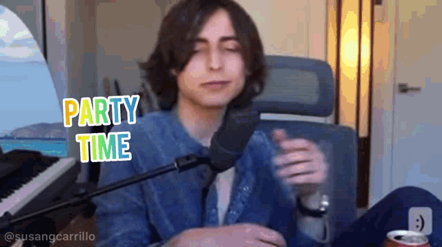 a young man is sitting in front of a microphone with the words party time above him