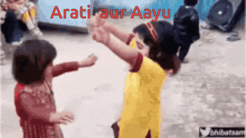 a boy and a girl are dancing in front of a sign that says ' arati aur aayu '