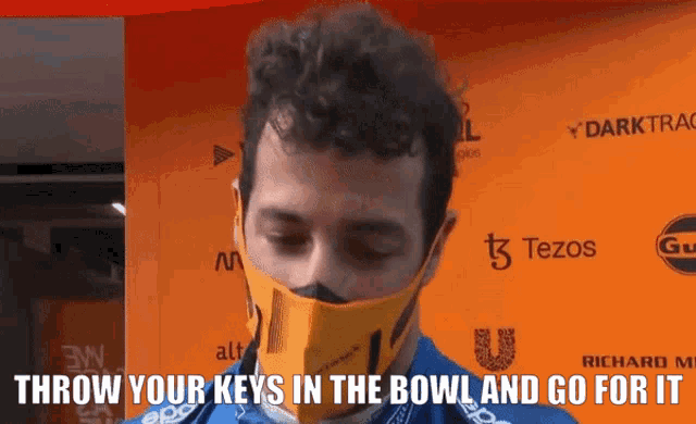 a man wearing a mask with the words " throw your keys in the bowl and go for it "