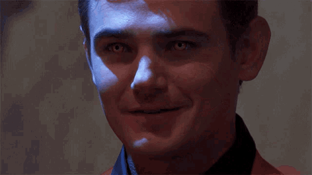 a close up of a man 's face smiling