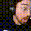 a close up of a man 's face wearing headphones and glasses .