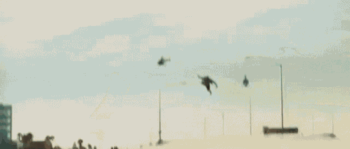 a group of helicopters are flying over a car .