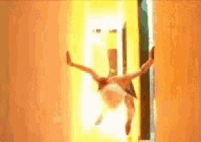 a person is doing a handstand in a hallway with their arms outstretched .