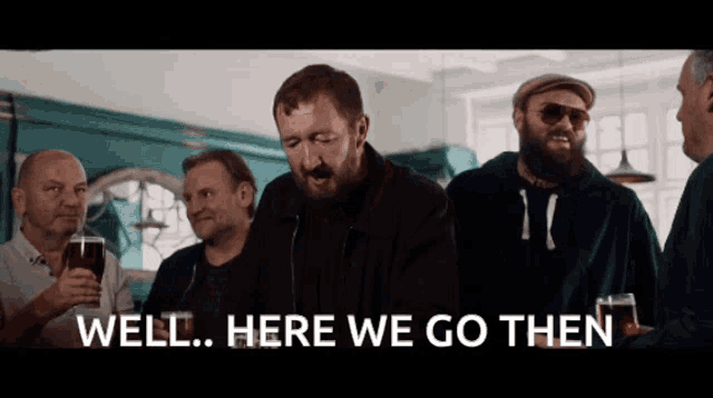 a group of men standing in a room with the words well here we go then on the bottom