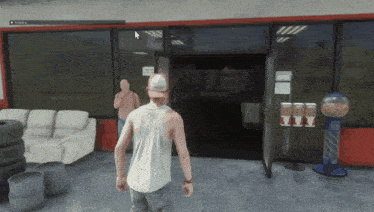 a man in a white tank top stands in front of a store that says auberg