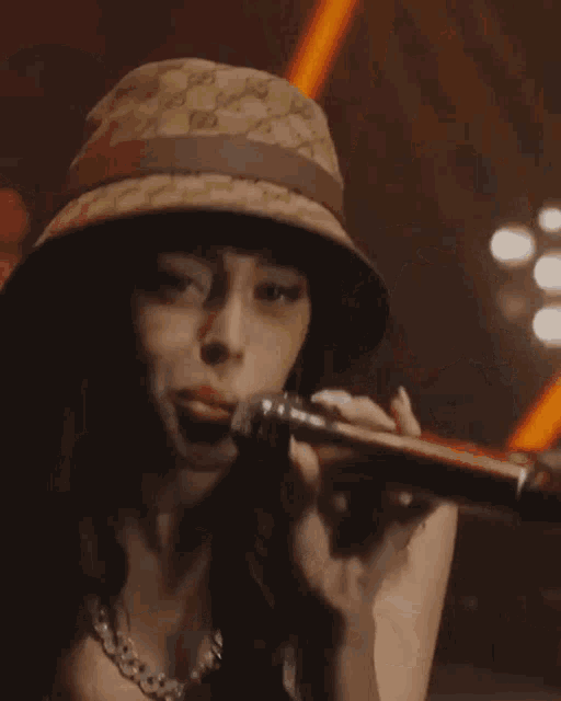 a woman singing into a microphone with calvin klein underwear
