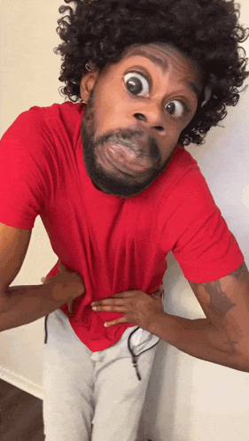 a man with a beard and curly hair is making a funny face